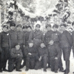 
						Jan Czwojdrak (4th from left). KoĹtubanka, USSR. January 1942. After the "Amnesty" troops gathered at KoĹtubanka camp and were transferred to the Navy and Air Force in the UK. You can see the gate and tents as well as small "eagles" on the caps, made from cans. Submitted by Karol Kubiak					
