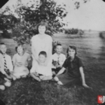
						Czesław is visible first on the left. His mother Wacława is in the centre sitting behind his younger brother Władysław and his non-identical twin brother Edmund is second on the right next to his mother. Photo taken in Marcinkance, near Grodno, circa 1927-28.					