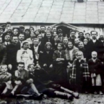 
						Helena's ister Anna’s wedding to Jósef Szeliga, not long before war broke out. Maria is on the groom’s left and Jan is next to the priest who is next to Anna. The photo is in front of the family home in Zarudzie.					