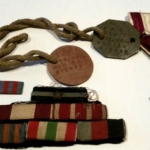 
						Cross of valour, dog tags and badges					