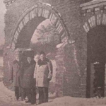 
						The main gate to the cemetery. Partly damaged. Ca 1947?					