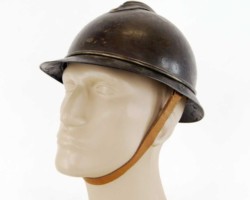 French helmet model 15 of the Adrian type
it consists of a body, pressed from sheet metal with a thickness of about 0.7 mm, a comb and roofs - front and rear. The canopies are connected with each other by rivets or welding, and the whole thing is attached to the body by rolling, creating a characteristic 3 mm thick thickening around the body. The edges of the canopies are folded up and rolled to make them rigid and to dull the edges. A double profiled comb is attached to the body with four folded rivets. At the top of the shell, covered with a crest, there is an oblong ventilation hole. The comb also has two ventilation cuts located at the surface of the body. These cuts were also to be used to put on a strap for attaching the helmet to the schoolbag. In the front part of the shell there are two rectangular holes with dimensions of 6 x 1.5 mm, located one above the other at a distance of 35 mm, and used to attach the badge (in this case, the holes are soldered in accordance with the order of 01.07.1930, because, according to experts, putting badges on a helmet reduces its combat value). The internal equipment of the helmet is a natural-colored leather insert, consisting of six lobes tied at the top with a shoelace, and a sweatband. The leather sweatband is separated from the helmet shell by a thick fabric strip and four spacers made of corrugated aluminum sheet. The interior fittings are attached to the shell with four folded holders, soldered to the interior surface of the shell over its edge. The lining of the helmet is a narrow, 10 mm wide, brown leather strap with adjustable sliding buckle without a pin. The lining is attached to metal catches, soldered to the shell. Adrian wz. 1915 were equipped with the Border Protection Corps.
Zbigniew Kulon's collection