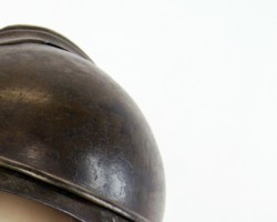French helmet model 15 of the Adrian type
it consists of a body, pressed from sheet metal with a thickness of about 0.7 mm, a comb and roofs - front and rear. The canopies are connected with each other by rivets or welding, and the whole thing is attached to the body by rolling, creating a characteristic 3 mm thick thickening around the body. The edges of the canopies are folded up and rolled to make them rigid and to dull the edges. A double profiled comb is attached to the body with four folded rivets. At the top of the shell, covered with a crest, there is an oblong ventilation hole. The comb also has two ventilation cuts located at the surface of the body. These cuts were also to be used to put on a strap for attaching the helmet to the schoolbag. In the front part of the shell there are two rectangular holes with dimensions of 6 x 1.5 mm, located one above the other at a distance of 35 mm, and used to attach the badge (in this case, the holes are soldered in accordance with the order of 01.07.1930, because, according to experts, putting badges on a helmet reduces its combat value). The internal equipment of the helmet is a natural-colored leather insert, consisting of six lobes tied at the top with a shoelace, and a sweatband. The leather sweatband is separated from the helmet shell by a thick fabric strip and four spacers made of corrugated aluminum sheet. The interior fittings are attached to the shell with four folded holders, soldered to the interior surface of the shell over its edge. The lining of the helmet is a narrow, 10 mm wide, brown leather strap with adjustable sliding buckle without a pin. The lining is attached to metal catches, soldered to the shell. Adrian wz. 1915 were equipped with the Border Protection Corps.
Zbigniew Kulon's collection