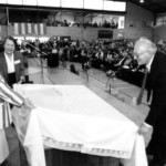 The 50th anniversary of the Polish children's arrival in New Zealand, Pahiatua Sports Stadium, 23 October 1994. Józef Zawada (right) and Krystyna Kołodyńska (2nd from left) help Governor-General Dame Catherine Tizard (left) to unveil a scale model of the camp, which is now in the Pahiatua Museum. Source: Polish Children’s Reunion Committee 2004. The 50th anniversary of the Polish children's arrival in New Zealand, Pahiatua Sports Stadium, 23 October 1994. Józef Zawada (right) and Krystyna Kołodyńska (2nd from left) help Governor-General Dame Catherine Tizard (left) to unveil a scale model of the camp, which is now in the Pahiatua Museum. Source: Polish Children’s Reunion Committee 2004.