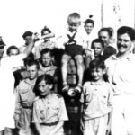 The Captain (far left) on board the Sontay with the Polish children, guardians and crew members Wacław Sumicz (left of Captain's hand), Mieczysław Bieniowski (below Captain's elbow), Andrzej Dawidowski (front left), Bolesław Żygadło (behind Dawidowski), Sister Monika Alexandrowicz (far right bottom), ship's officer (left of Sister). Source: Polish Children’s Reunion Committee 2004.