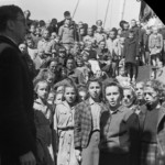 Polish Consul, Kazimerz Wodzicki, on board US General Randall. Part of the welcoming group on board the General Randall at Wellington. Standing in Front Row (l-r): Polish Consul General Kazimierz Antoni Wodzicki, Helena Pilarska, Janina Dźwiniel, Irena Woźniak, Stefania Kozera, Krystyna Skwarko Disk 34442 - Reference No.: F-3633-1/2 Photographer: John Dobree Pascoe from the John Pascoe Collection, Alexander Turnbull Library, Wellington, N.Z. Permission of the Alexander Turnbull Library must be obtained before any reuse of this image. Polish Consul, Kazimerz Wodzicki, on board US General Randall. Part of the welcoming group on board the General Randall at Wellington. Standing in Front Row (l-r): Polish Consul General Kazimierz Antoni Wodzicki, Helena Pilarska, Janina Dźwiniel, Irena Woźniak, Stefania Kozera, Krystyna Skwarko Disk 34442 - Reference No.: F-3633-1/2 Photographer: John Dobree Pascoe from the John Pascoe Collection, Alexander Turnbull Library, Wellington, N.Z. Permission of the Alexander Turnbull Library must be obtained before any reuse of this image.