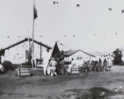 Sister Janina Ptak taking an oath before the banner of the Jamnagar troop, Balachadi, 1945; source: from the collection of Wiesław Stypuła Sister Janina Ptak taking an oath before the banner of the Jamnagar troop, Balachadi, 1945; source: from the collection of Wiesław Stypuła
