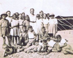 Polish children with a teacher in front of the school tent in the Country Club camp, 1943; source: from the collection of Wiesław Stypuła Polish children with a teacher in front of the school tent in the Country Club camp, 1943; source: from the collection of Wiesław Stypuła